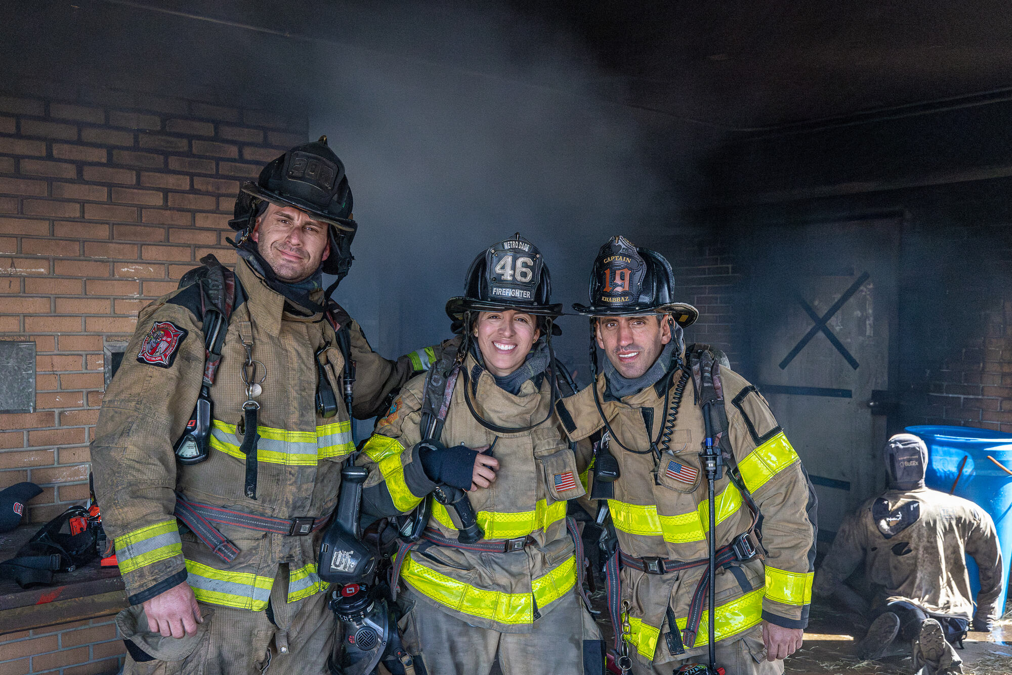 Firefighters silhouetted against smoke at first light